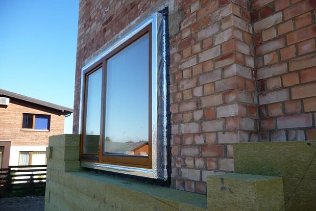 Energiškai efektyviuose namuose langai turi būti montuojami šilumos izoliaciniame sluoksnyje.